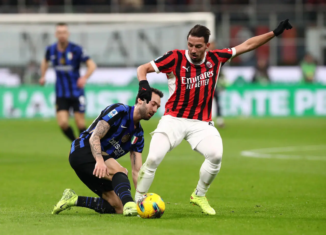 MILAN, ITALY - FEBRUARY 02: Ismael Bennacer of AC Milan is put under pressure by Hakan Calhanoglu