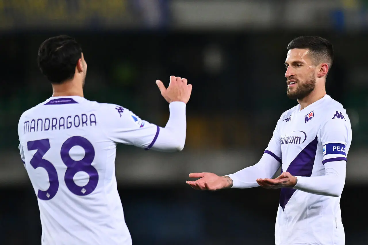 Cristiano Biraghi of ACF Fiorentina celebrates with teammate Rolando Mandragora