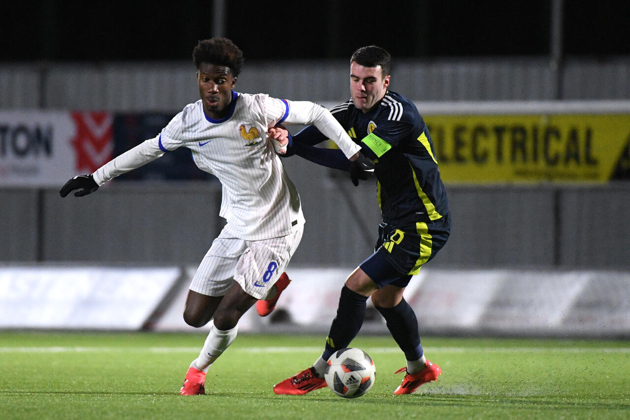 Aladji Bamba of France runs with the ball whilst under pressure from Lennon Miller of Scotland during the UEFA U19 EURO Qualifying match between Scotland and France at Forthbank Stadium on November 19, 2024 in Stirling, Scotland.