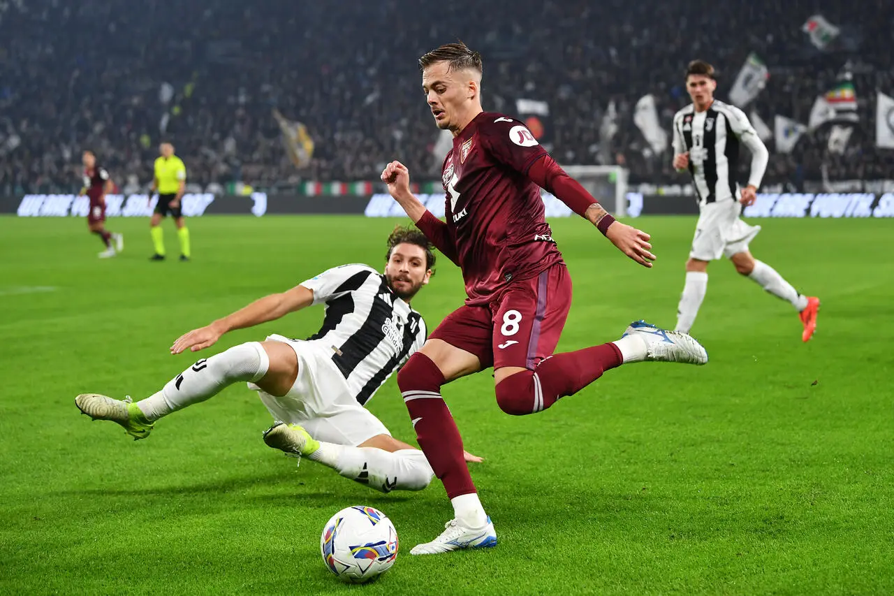 Ivan Ilic of Torino is challenged by Federico Gatti of Juventus during the Serie A match between Juventus and Torino at Juventus Stadium on November 09, 2024 in Turin, Italy.
