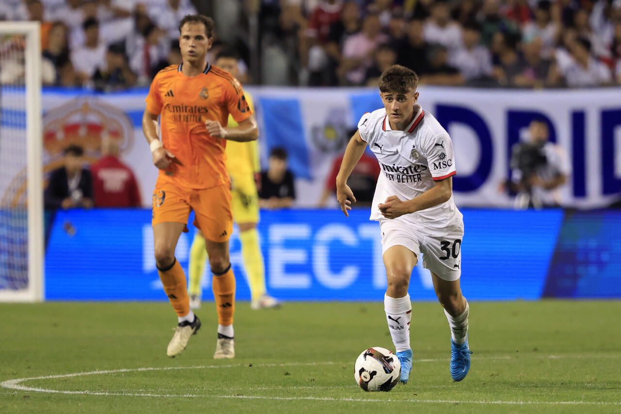 Mattia Liberali of AC Milan drives the ball during a Pre-Season Friendly match between AC Milan and Real Madrid at Soldier Field Stadium on July 31, 2024 in Chicago, Illinois.