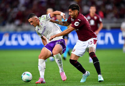 Roberto Piccoli of Fiorentina competes for the ball with Guillermo Maripan of Torino during the Serie A match between Torino FC and ACF Fiorentina at Stadio Olimpico di Torino on August 31, 2025 in Turin, Italy.
