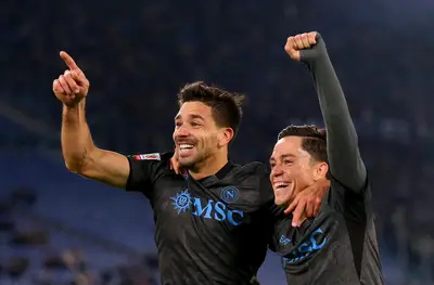 Giovanni Simeone celebrates scoring his team's first goal with teammate Giacomo Raspadori during the Coppa Italia match between SS Lazio and Napoli at Stadio Olimpico on December 05, 2024 in Rome, Italy.